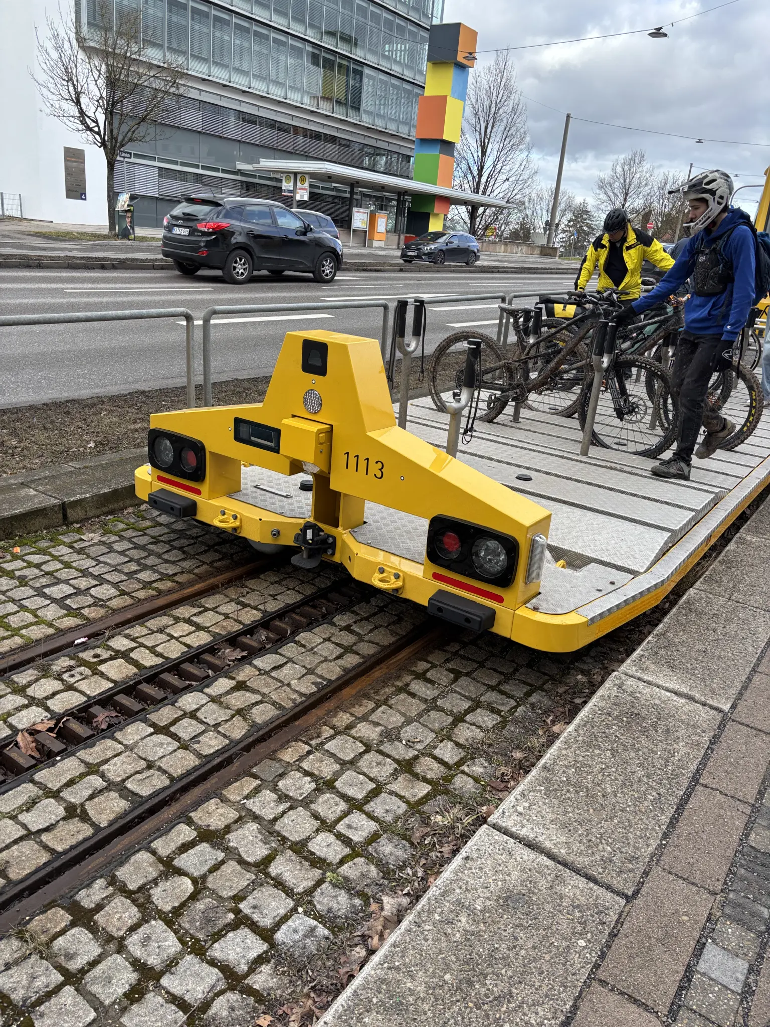 a flat bicycle trailer with its on headlights on a cog railway