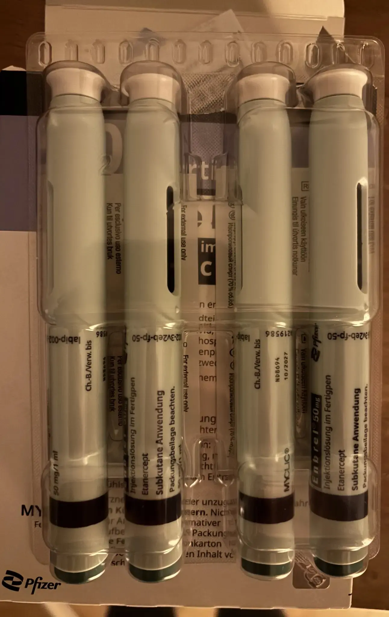 4 myclic(tm) by pfizer (tm) pens with etanercept inside, packed tightly into a plastic shell
