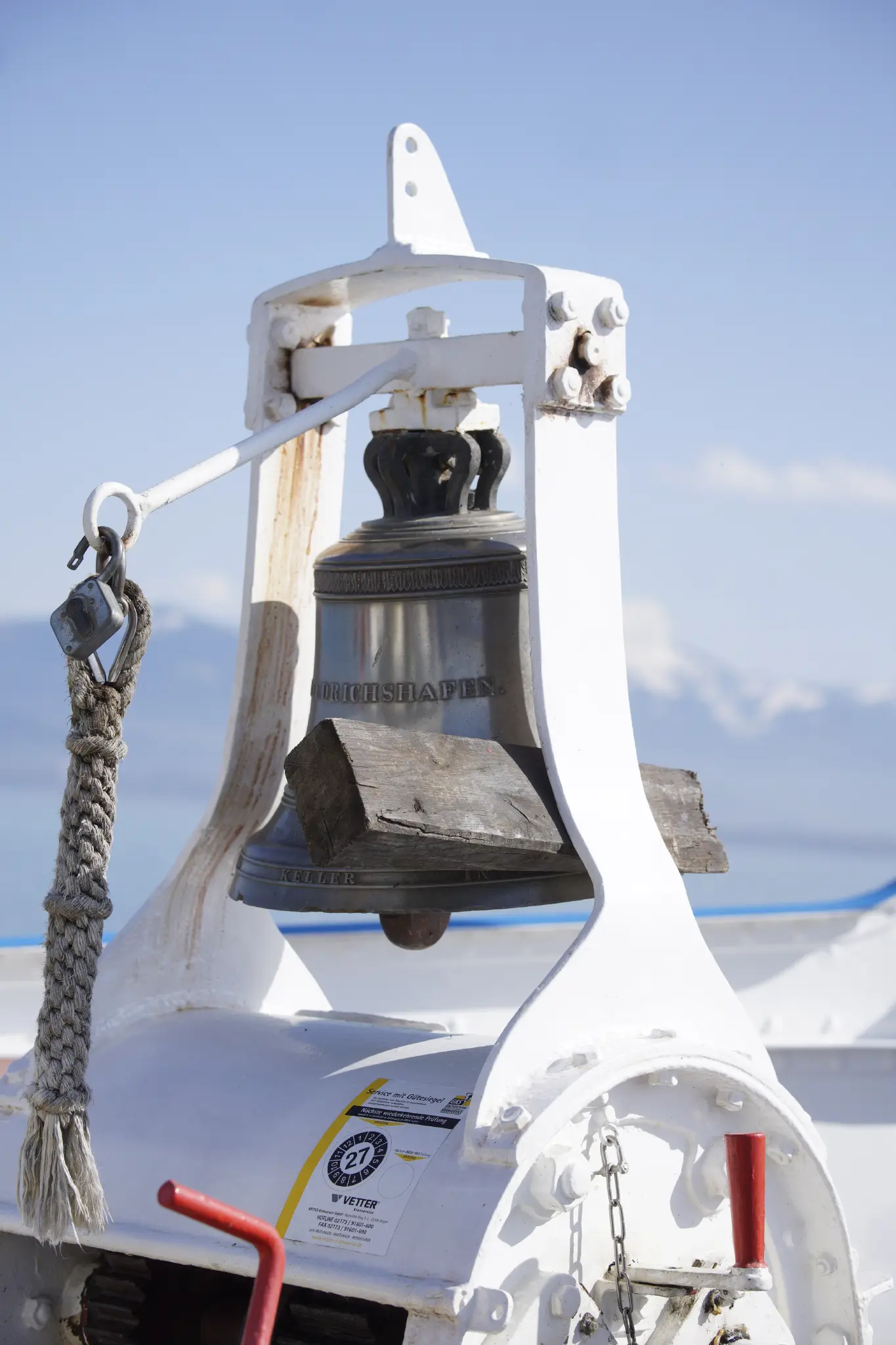 a bell on a boat with an engraving reading “friedrichshafen”, the same bell as in the photo above.