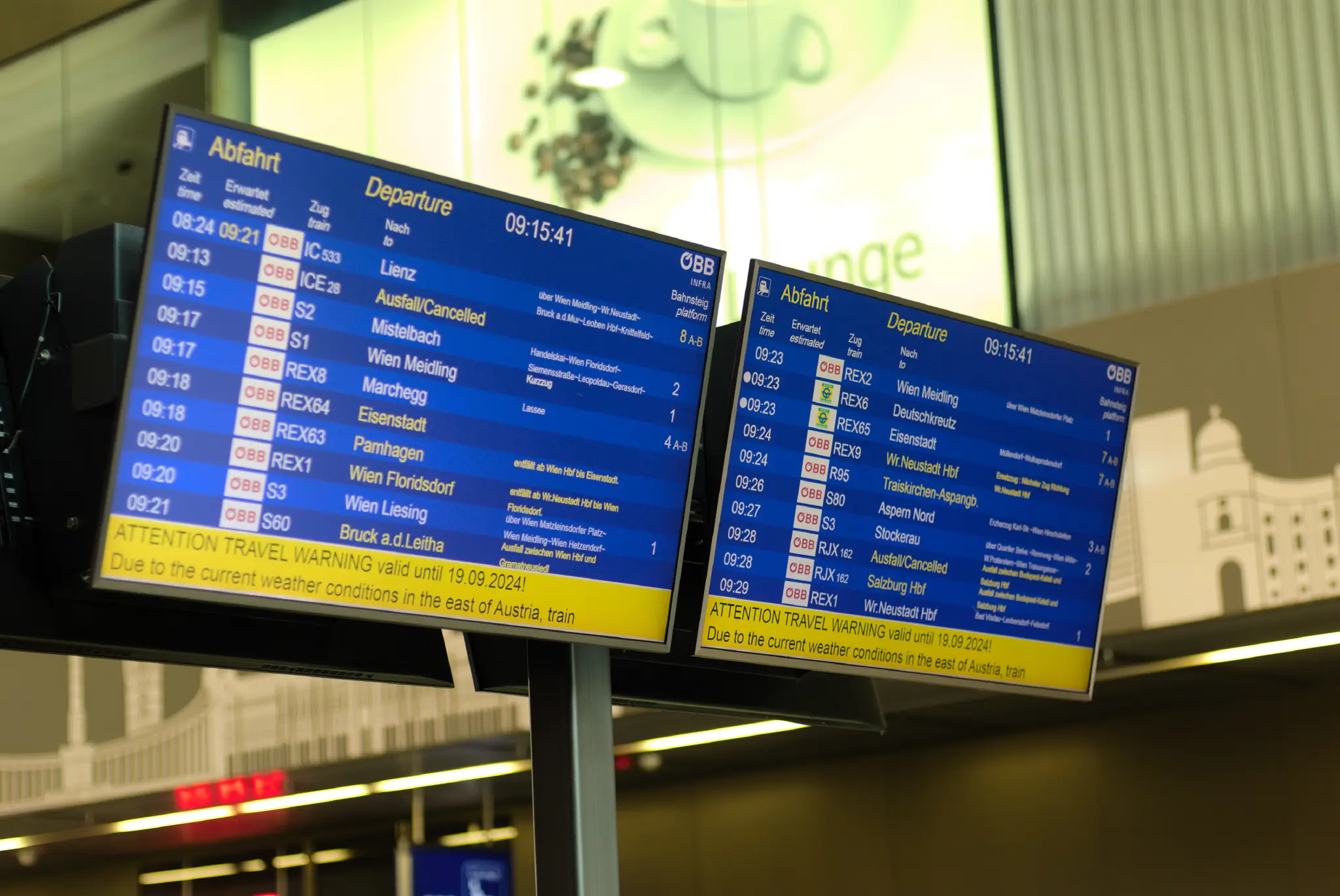 two train departure boards in vienna main station, showing about half of the trains being cancelled or disrupted. at the bottom of the screens a bright yellow warning banner is shown, the text on it reads:
Attention Travel Warning valid until 19.09.2024!
Due to the current weather conditions in the east of Austria, train